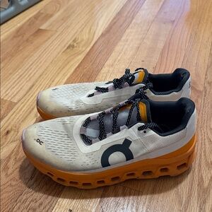 On Running Cream and Orange Athletic Shoes